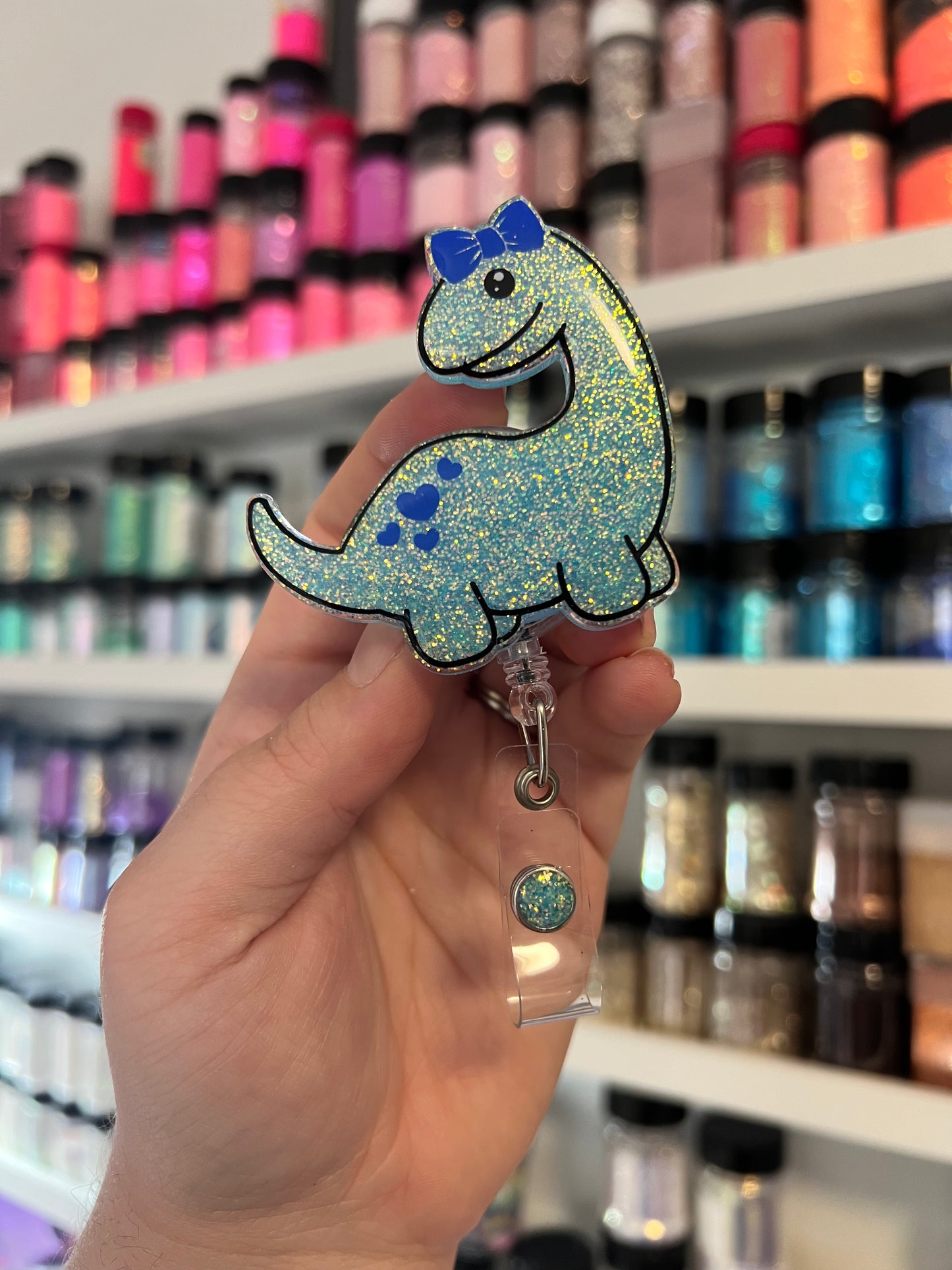 Dino with Bow Badge Reel